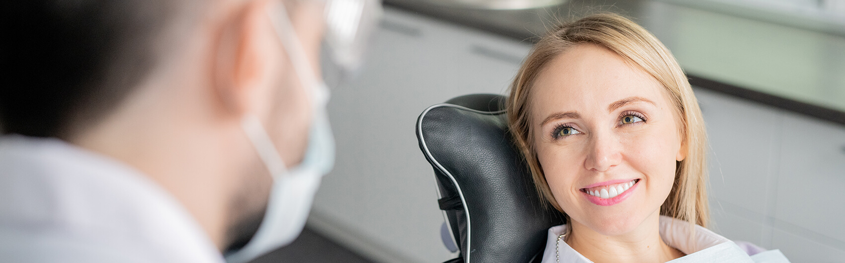 smiling woman sitting in a dental chair